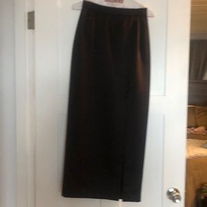 Long satin skirt with front slit to upper thigh, and attached buttons.